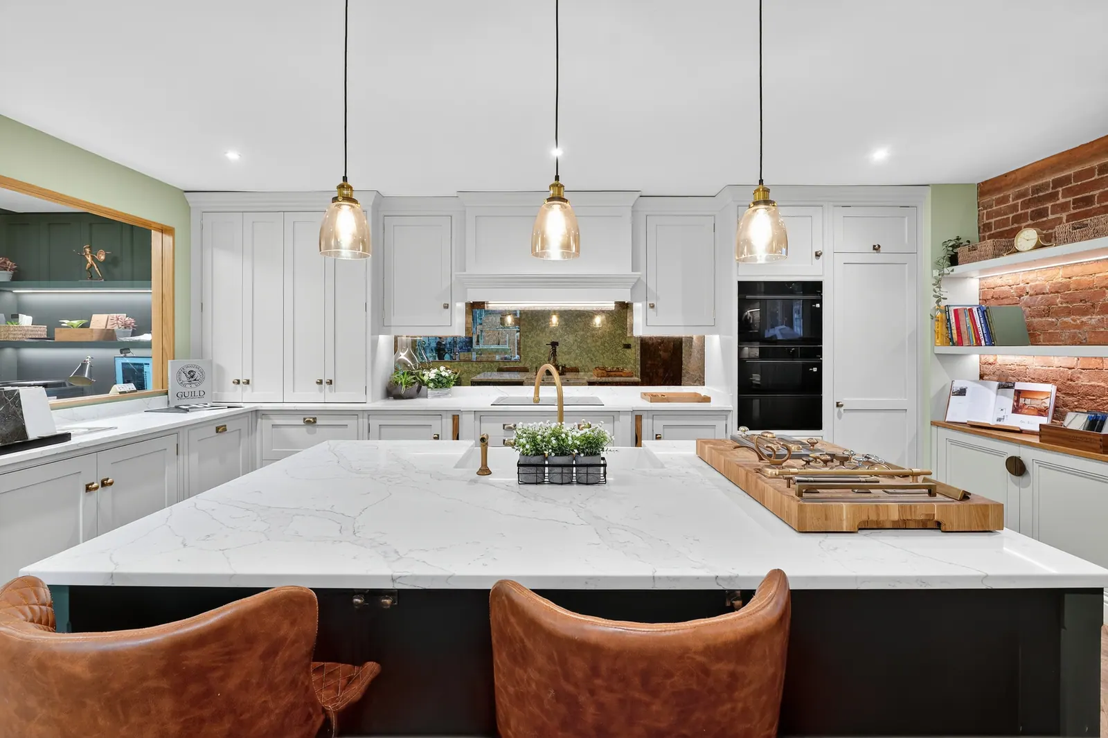 The Charles Vivian showroom — painted kitchen with marble-topped island