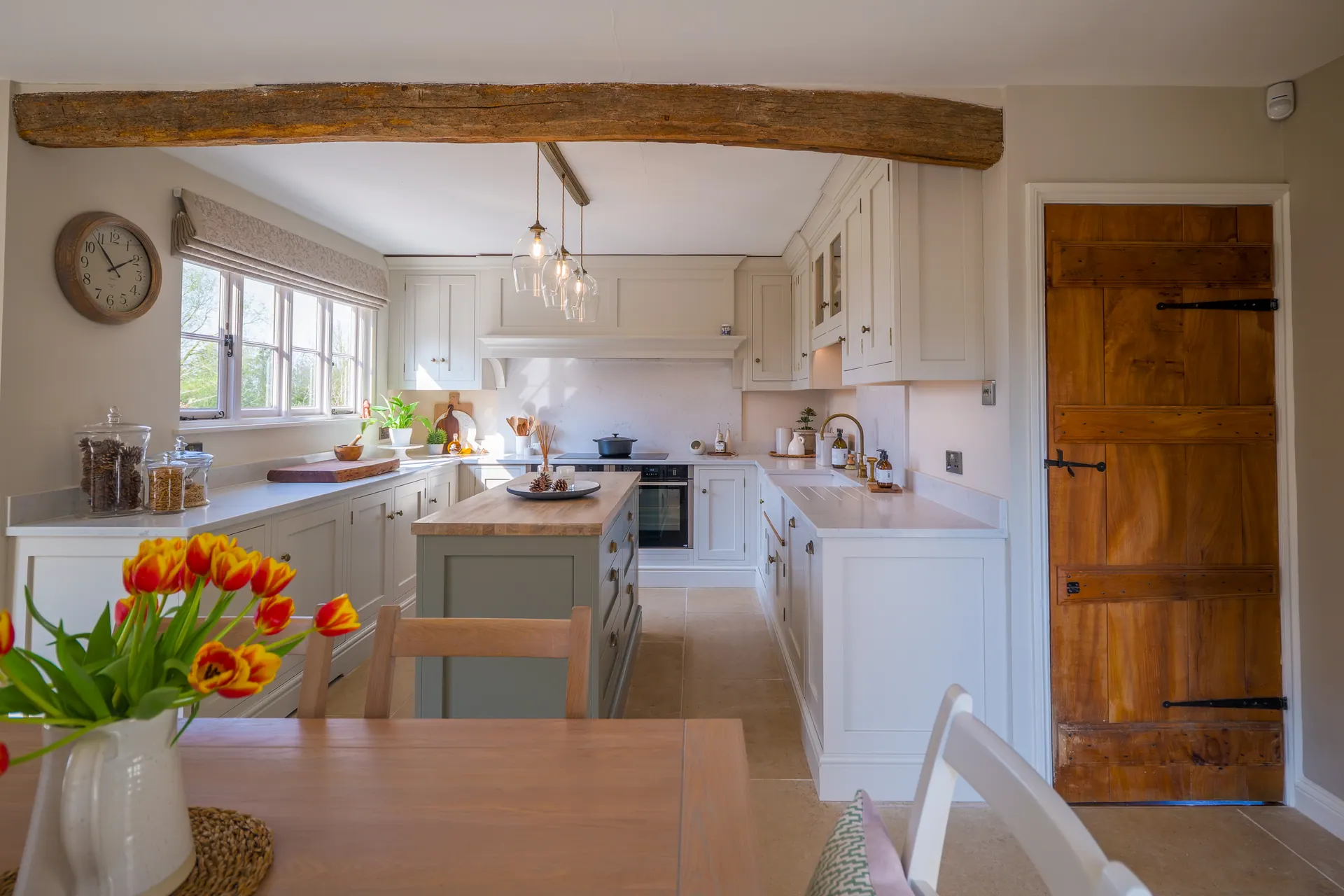 A beamed cottage kitchen by Charles Vivian
